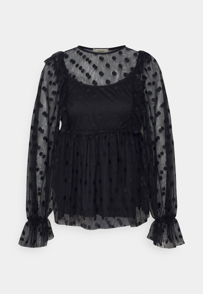 Blusa preta com um sobreposição transparentes apresentando um padrão de bolinhas. Mangas franzidas; corpete justo abaixo de uma barra peplum solta. Textura suave.