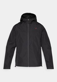 Must mustaga, mis on valmistatud kergest veekindlast kangast. Omab ees olevat tõmblukku, küljetaskuid ja väikest logo rinnal.