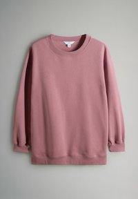 Gaiši rozā džemperis ar apaļu kakla izgriezumu, garām piedurknēm un ribotām piedurknēm. Mīksts audums ar nedaudz teksturētu apdari, brīva piegriezuma stils.