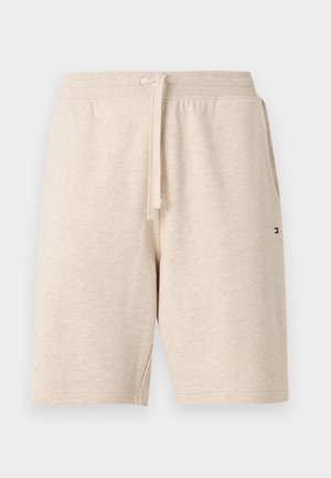 Béžové šortky z bavlnenej zmesi s elastickým pásom, šnúrkou, bočnými vreckami a malým logom Tommy Hilfiger v tvare vlajky na pravej strane.