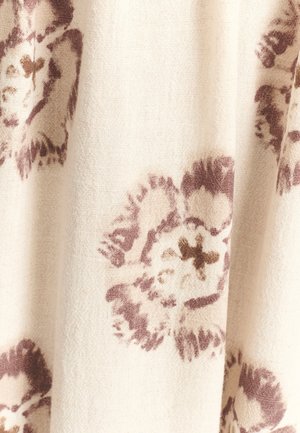 Floral-patterned fabric in cream with muted purple and brown hues. Soft texture with prominent flower designs and subtle shading.