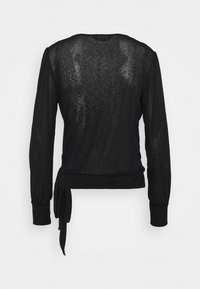 Transparent svart långärmad blus med rund halsringning, åtsittande ärmslut och detalj med sidoknytning vid fållen.