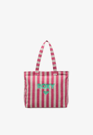 Sac cabas rayé vertical rose et beige avec deux anses et texte et logo "ROXY" verts sur le devant.
