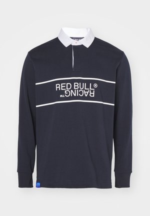 Polo a maniche lunghe blu navy con colletto bianco, grafica rossa e bianca del logo "RED BULL RACING" sul davanti e un accento blu sull'orlo.