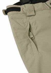 Beżowe lekkie spodnie o teksturowanym wykończeniu, z boczną kieszenią zamykaną na zamek oraz regulowanym paskiem w talii dla pewnego dopasowania.
