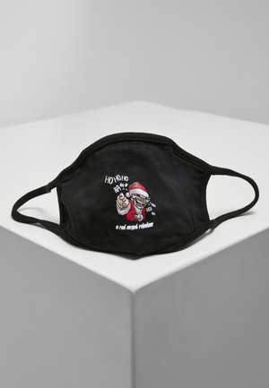 Masque facial en coton noir avec un design brodé d'un personnage de Père Noël, accompagné de texte en blanc, le tout sur une surface géométrique grise.