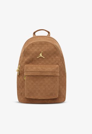 Brown suede backpack with a textured pattern, gold hardware, front pocket, and a gold Jumpman logo on the front. Zipper closure.