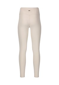 Leggings di un beige chiaro realizzati in tessuto elasticizzato. Design a vita alta con una texture liscia e uno stile minimalista. Senza pattern visibili o elementi metallici.