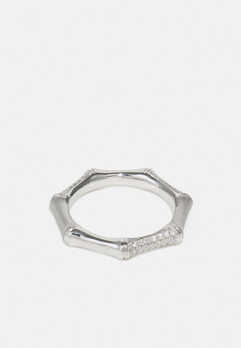 Silver ring with octagonal shape, featuring textured and smooth surfaces, accented with small clear gemstones along two sides.