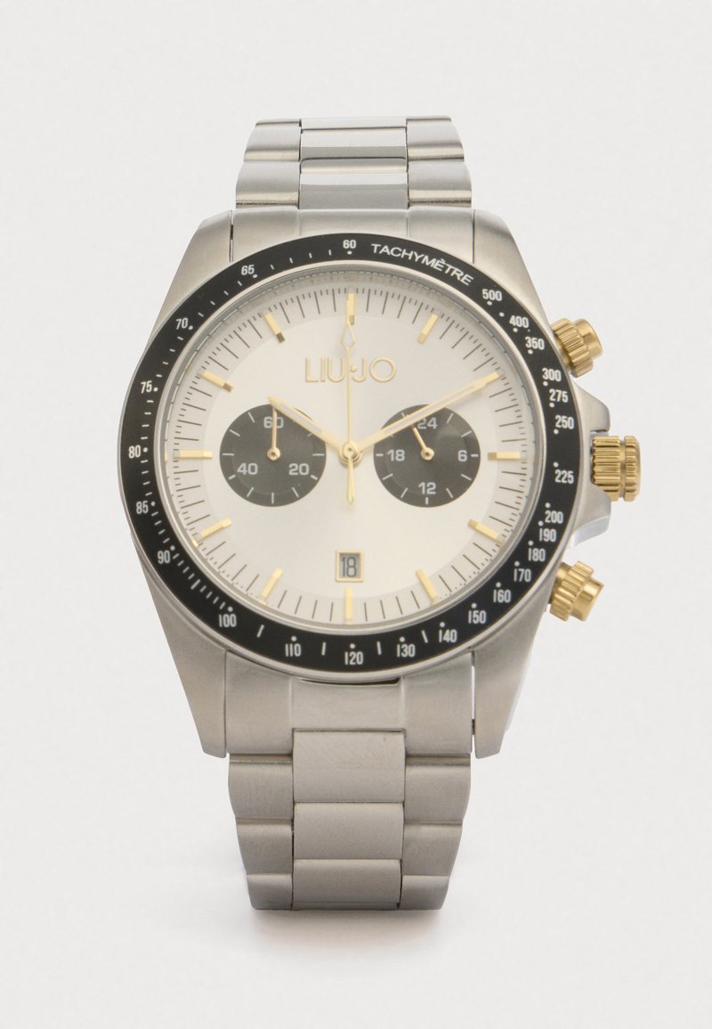 Silberner Edelstahlchronograph mit rundem weißen Zifferblatt, schwarzer Tachymeterskala und goldenen Akzenten. Verfügt über zwei Nebenuhren und ein Datumsfenster.