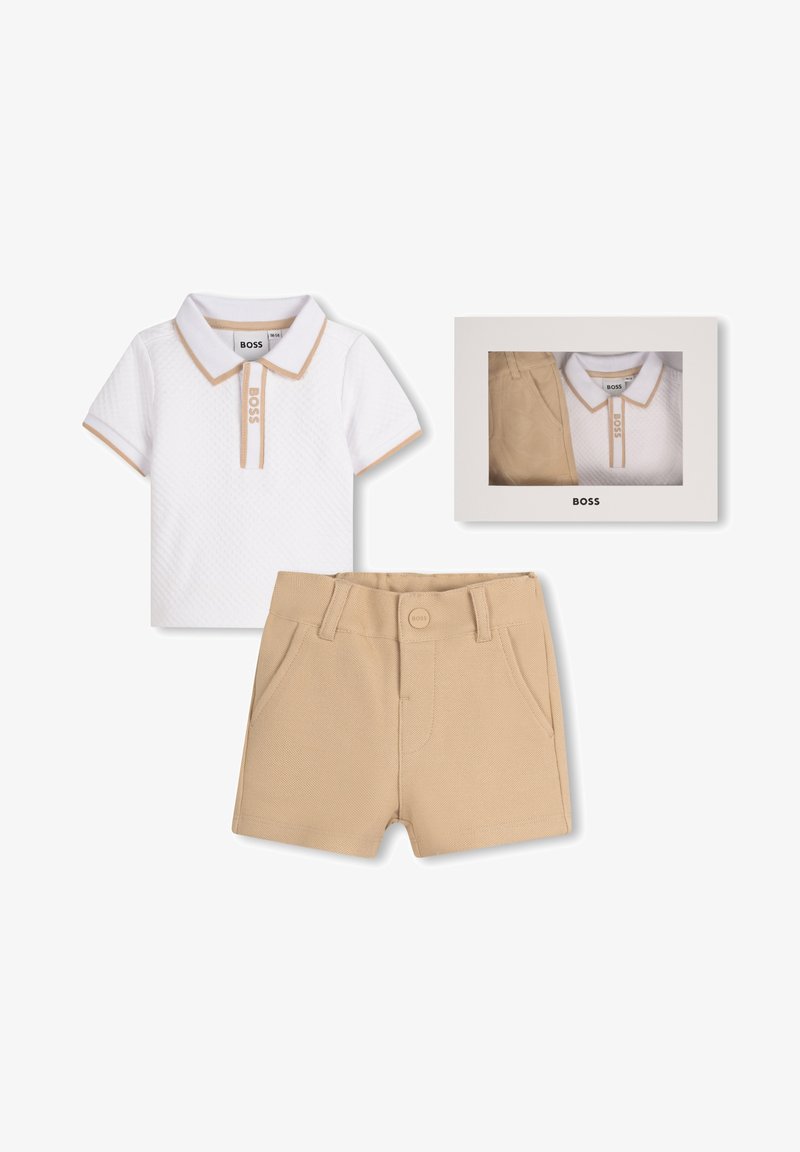 White polo shirt with beige accents and a textured pattern, paired with beige shorts featuring a front button and pockets, in a box.