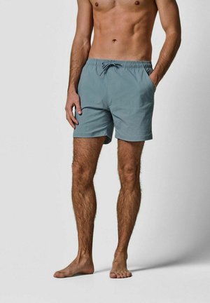Heren zwemshort in lichtblauwe stof, voorzien van een elastische tailleband met trekkoord, een losse pasvorm en zijzakken.
