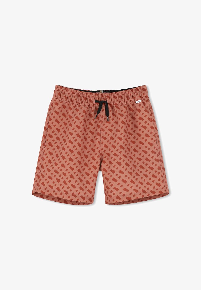 Shorts de bain pour homme de couleur rouille avec un motif géométrique dans des teintes plus sombres. Dotés d'une taille élastique avec un cordon de serrage noir et une étiquette de marque.