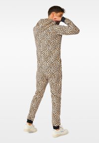 Leopard print onesie in soft fabric, features a hood, long sleeves, and fitted ankles. Black accents at cuffs and ankles.
