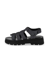 Black denim sandals with multiple crisscross straps, a round toe design, and a chunky black rubber sole featuring tread patterns.