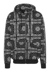 Felpa nera con cappuccio caratterizzata da una stampa bandana con motivi bianchi, maniche lunghe, zip frontale e due tasche anteriori. Tessuto testurizzato con cappuccio.