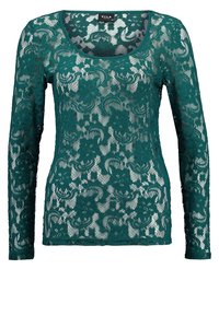 Tealfärgad spetsblus med lång ärm och rundad halsringning, prydd med blommönster och en semi-transparent textur, utformad för en åtsittande silhuett.