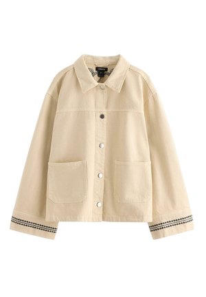 Beige skjortejakke med to forlommer, krave, lange ærmer og sort mønstret kant på ærmekanter.