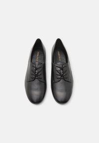 Black leather lace-up shoes with a smooth texture, rounded toe, and minimal detailing. Features a branded insole lining.