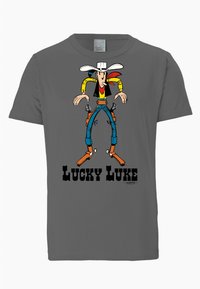 Graues T-Shirt mit einem bunten Cartoon-Charakter, Lucky Luke, der einen Cowboyhut und Zubehör trägt. Fett gedruckter Text "LUCKY LUKE" darunter.