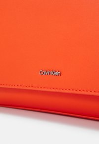 Calvin Klein MUST SHOULDER BAG - Keresztpántos táska - flame