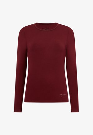 Burgunderfarbene langärmelige Bluse mit rundem Ausschnitt, aus einem glatten Stoff und mit einem dezenten Logoakzent am Saum.