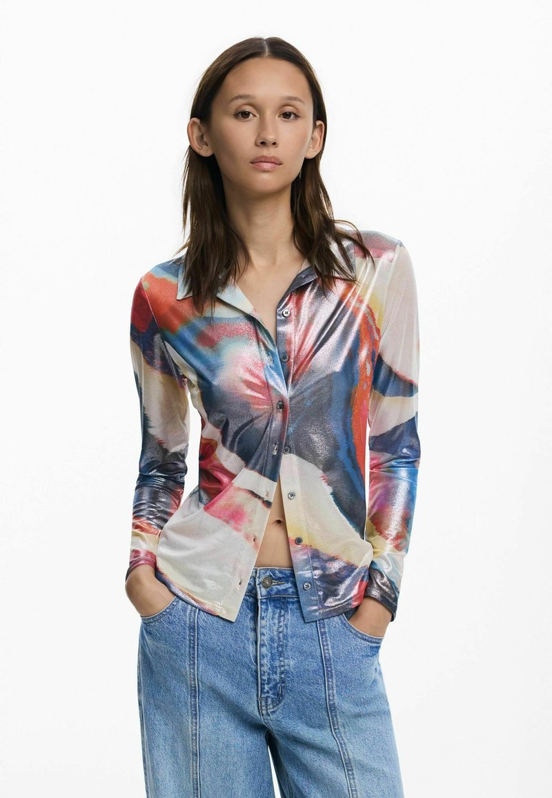 Long-sleeve button-up shirt with a colorful abstract design in shades of red, blue, and cream. Made of shiny, lightweight fabric.