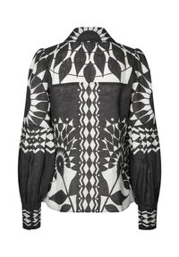 Black and white patterned blouse featuring a collared neckline, puffed sleeves, and intricate geometric and floral designs throughout.
