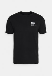 Černé tričko s krátkým rukávem a malým bílým nápisem "DKNY est. 1989 oficiální uniforma New Yorku" na levé horní straně hrudi.