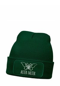 Dark green knitted beanie with ribbed texture, featuring a rectangular patch with a white butterfly design and the text "ALTER FALTER."