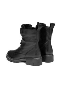 Black leather ankle boots with chunky soles and fur lining, shown from a rear-side angle on a white background.