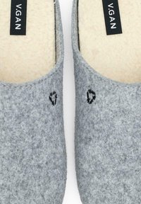 Gray felt slippers with a soft beige insole, featuring black embroidered accents resembling hearts on each side. Label reads "V.GAN."