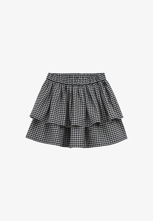 Gonna a quadri gessati bianca e nera con tre strati di rouches e una vita elastica. Tessuto leggero con un aspetto texturizzato.