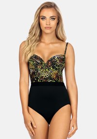 Jednoczęściowy strój kąpielowy z kolorowym nadrukiem zwierzęcym na górze w odcieniach zieleni, czerni i pomarańczy. Czarna dolna część z wysokim stanem. Regulowane ramiączka.