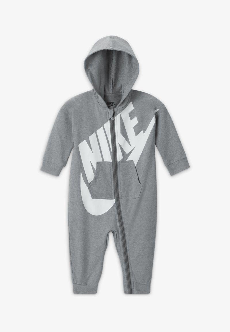 Tuta con cappuccio grigio in cotone con un grande logo Nike bianco, zip frontale e tasca a marsupio. Maniche lunghe e cavigliere elastiche.