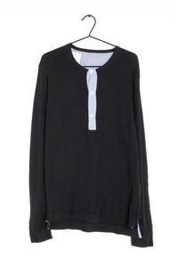 Black long-sleeve shirt with a round neckline, featuring a vertically striped button placket in blue and white. Soft fabric, relaxed fit.