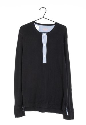 Black long-sleeve shirt with a round neckline, featuring a vertically striped button placket in blue and white. Soft fabric, relaxed fit.