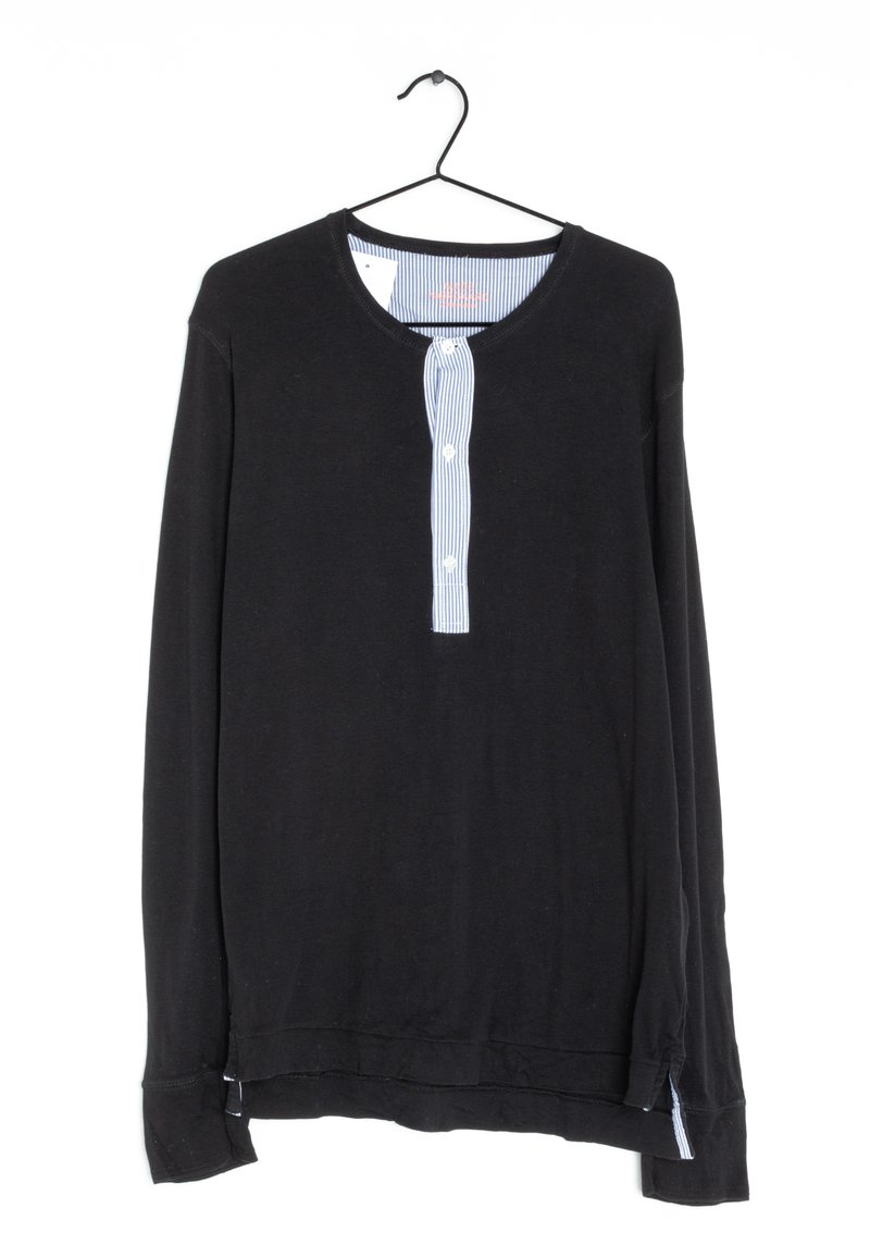 Black long-sleeve shirt with a round neckline, featuring a vertically striped button placket in blue and white. Soft fabric, relaxed fit.