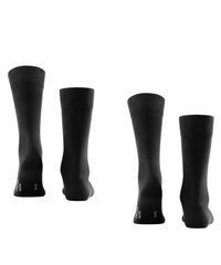 Calcetines de algodón negros con puños acanalados y una textura suave, mostrados desde diferentes ángulos. Presentan letras blancas en las suelas.
