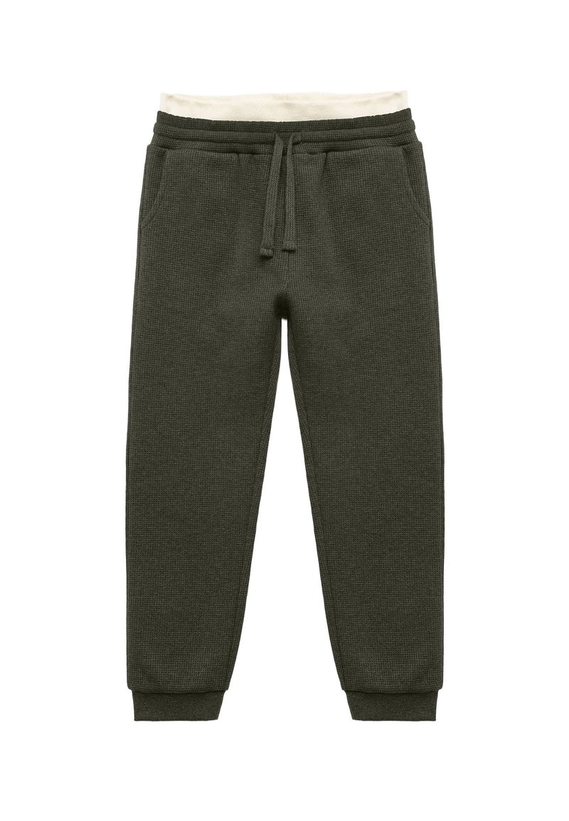 Mörkgrön, strukturerad stickad sweatpants med resårmidja, crèmefärgad innerfoder och åtsittande manschetter. Har två sidofickor.