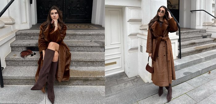 Ruskea tekoturkistakki, jossa on vyö, polven korkeudella olevat ruskeat mokkanahkasaappaat ja kontrastinvärinen ruskea käsilaukku kivisillä portailla. Tyylikäs ja runsas muotoilu.