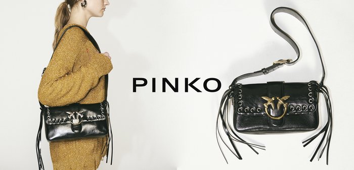 Black leather handbag featuring gold hardware, fringed details, and a circular clasp with bird accents. The design is compact and rectangular.