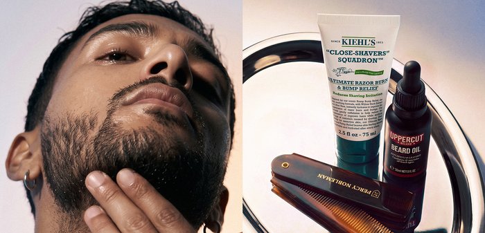 Homme barbu touchant son menton à côté d'une crème apaisante pour brûlure de rasoir, une bouteille d'huile à barbe et un peigne pliant sur une surface réfléchissante.
