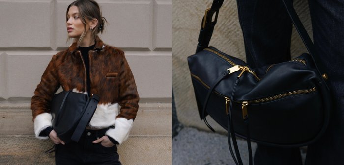 Femme portant une veste en fourrure marron et blanche, un haut noir et un pantalon, tenant un grand sac noir, debout contre un mur beige texturé.