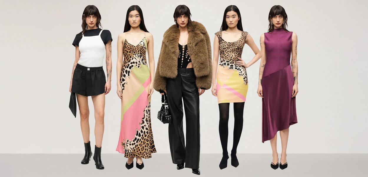 Five women stand in a row wearing various outfits: a black skirt, animal print dresses, a fur jacket with leather trousers, and a purple asymmetrical dress.
