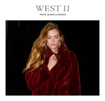 Burgundy faux fur coat with a wide collar, button closure, and a soft texture, worn with long, dangling earrings against a dark background.