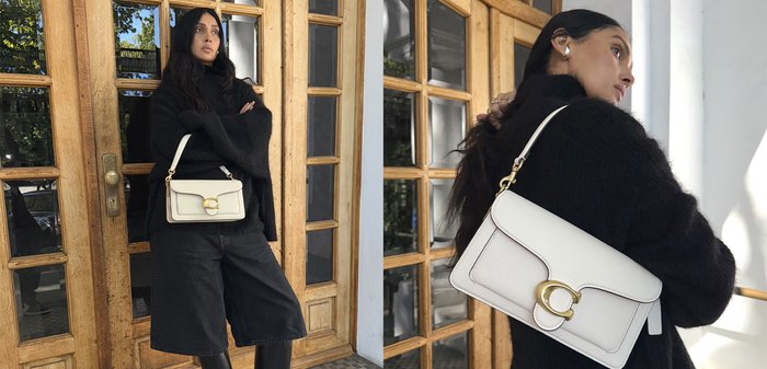 Handtasche aus weißem Leder mit strukturierter Oberfläche, ausgestattet mit einem Verschluss aus goldfarbenem Metall und einem abnehmbaren Schulterriemen.