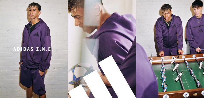 Completo tracksuit adidas Z.N.E. viola, con hoodie zip-up e pantaloni corti, caratterizzato da strisce nere a contrasto. Tessuto morbido e vestibilità rilassata.