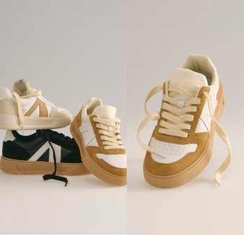 Sko i krem, svart og beige nyanser, med semsket skinn og gummi teksturer, rund tå, perforert detaljering og kontrasterende striper.