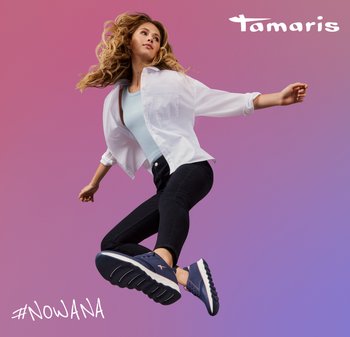 Blue athletic shoes with white soles, worn with black jeans and a white shirt, on a gradient pink background. "#NOWANA" text below.